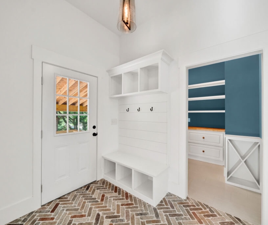 Residential restoration service in Jasper GA featuring a rebuilt entryway with custom mudroom storage, white shiplap walls, and updated flooring.